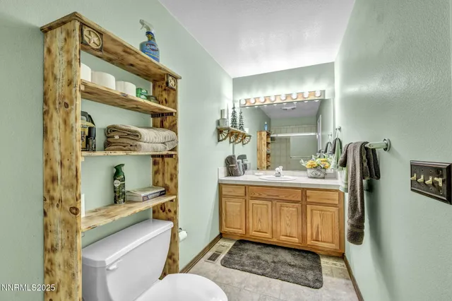 a bathroom with a sink a toilet and shower curtain