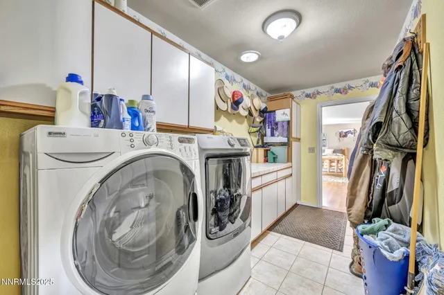 a view of washer and dryer with kitchen flooring