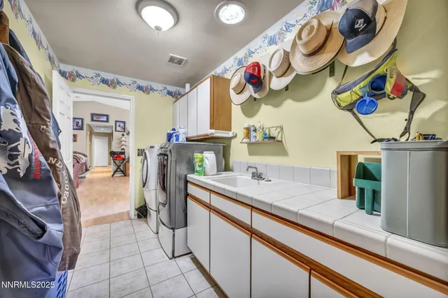 a kitchen with a sink and chandelier