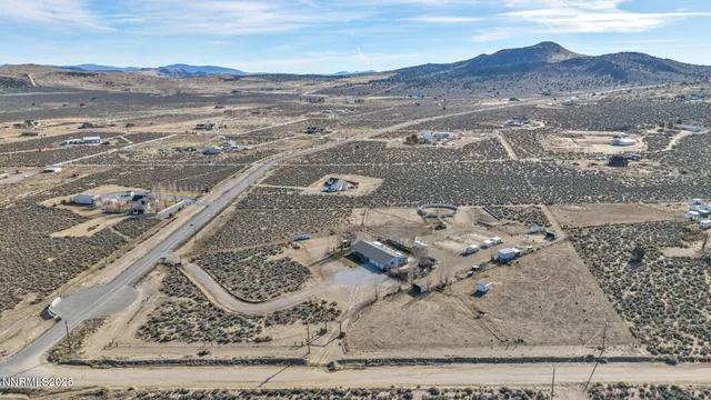 a view of a terrace with furniture and a mountain