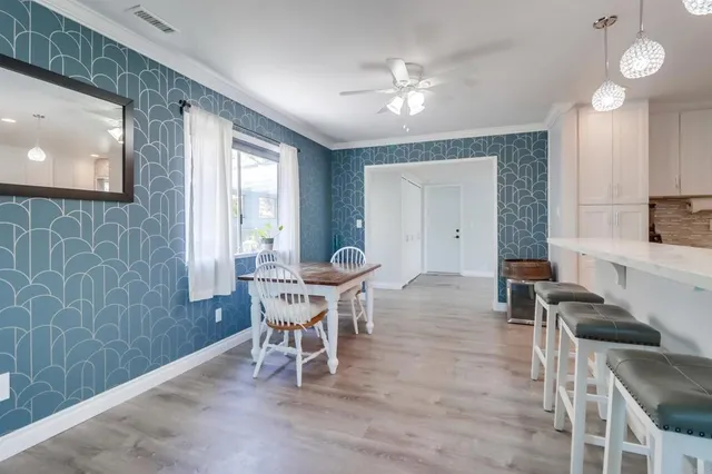 a view of a dining room with furniture and chandelier