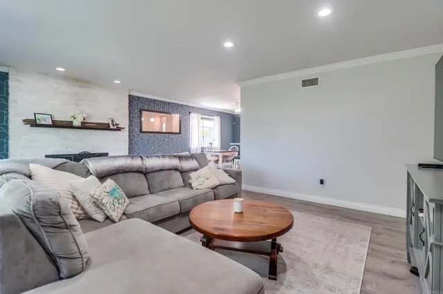 a living room with furniture and a large mirror