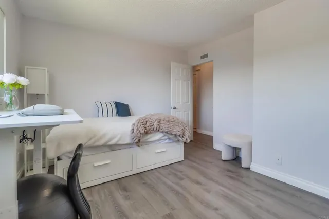 a bedroom with a bed and a table