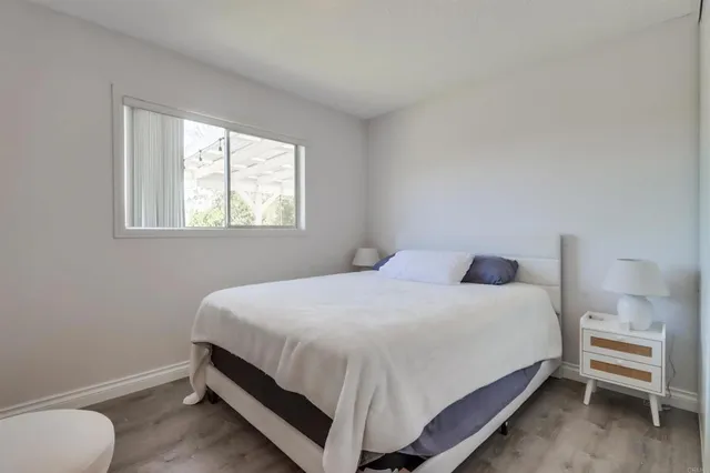 a large bed sitting in a bedroom next to a window
