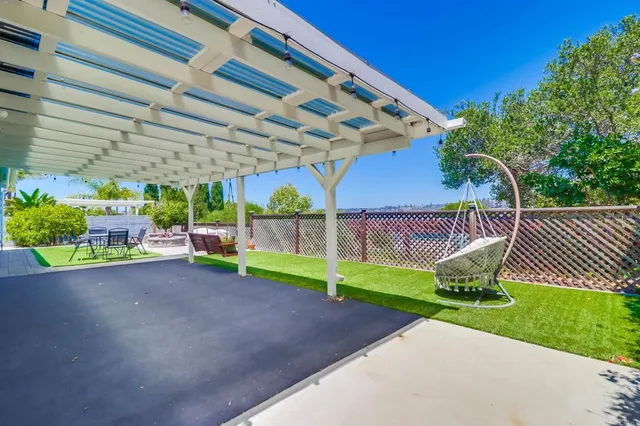 a view of a backyard with plants and table