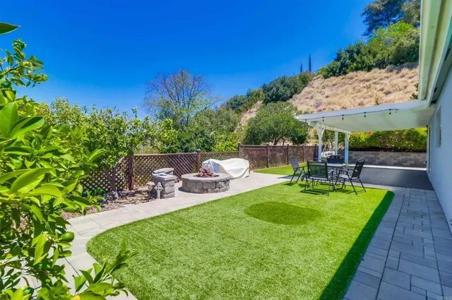 a view of a patio with chairs and plants