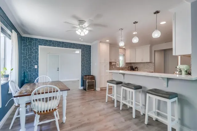 a kitchen with cabinets and chairs