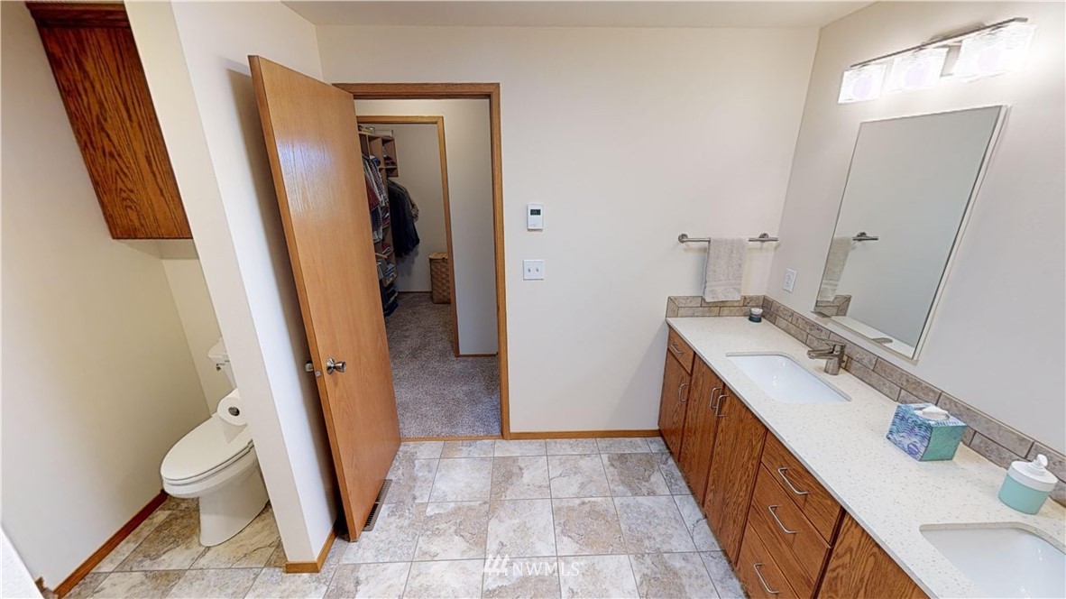 16936 Bradshaw Road Mount Vernon, WA 98273 - Photo 14 of 25 a bathroom with a sink a toilet and a mirror