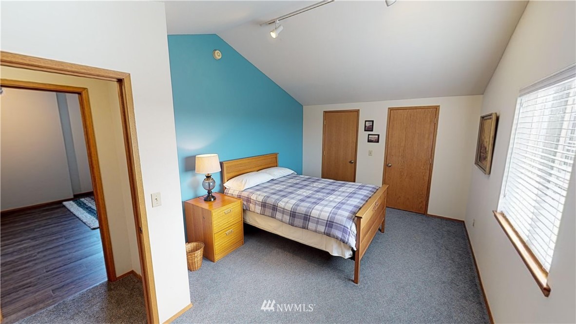 16936 Bradshaw Road Mount Vernon, WA 98273 - Photo 22 of 25 a bedroom with a bed and wooden floor