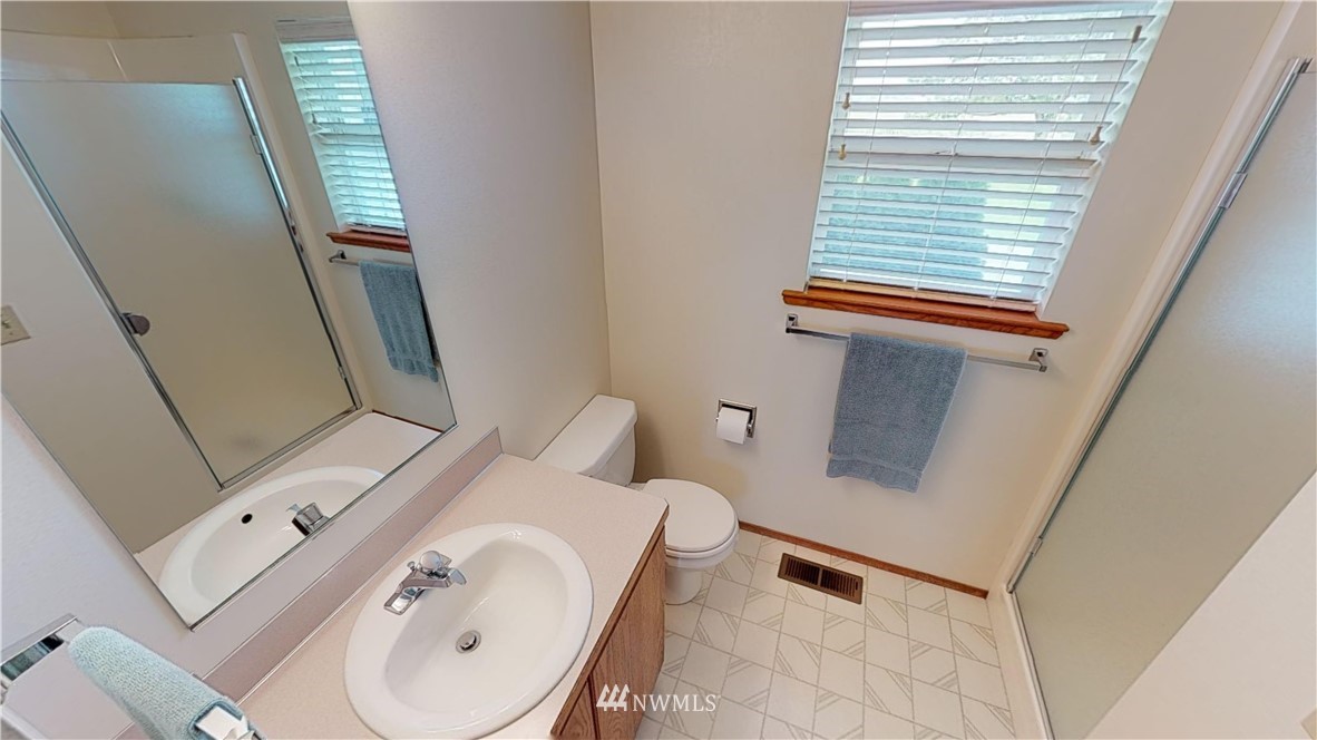 16936 Bradshaw Road Mount Vernon, WA 98273 - Photo 23 of 25 a bathroom with a toilet sink and mirror