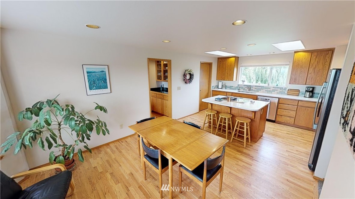 16936 Bradshaw Road Mount Vernon, WA 98273 - Photo 9 of 25 a living room with furniture a dining table and wooden floor