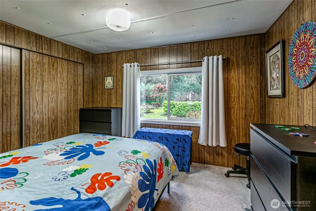 a bedroom with furniture and a baby crib