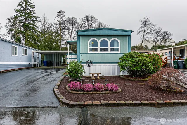 a front view of a house with a garden