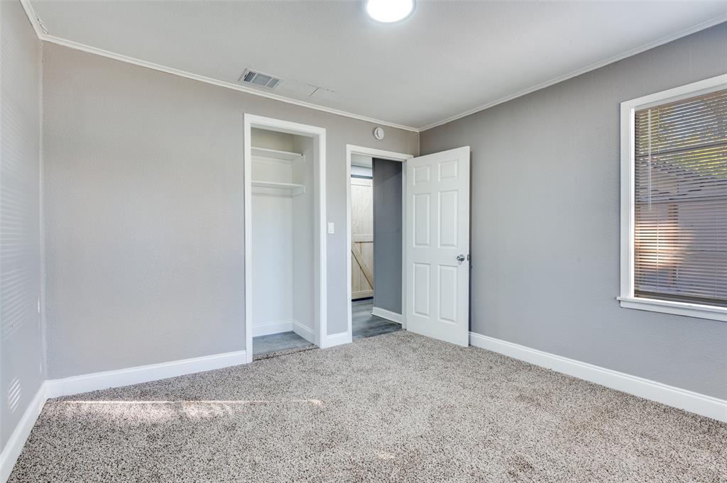 421 West 8th Street Lancaster, TX 75146 - Photo 19 of 25 an empty room with windows and closet