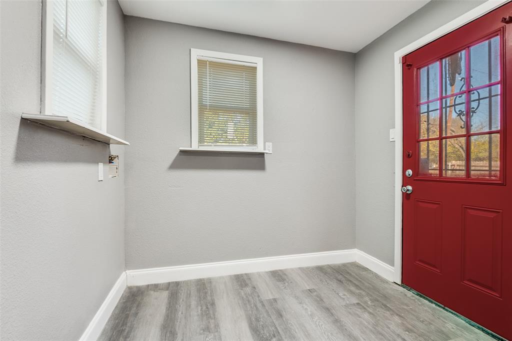 421 West 8th Street Lancaster, TX 75146 - Photo 20 of 25 a view of an empty room with wooden floor and a window