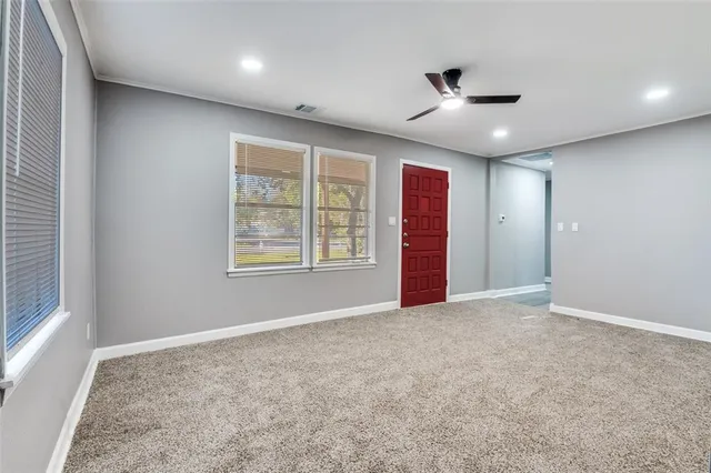 an empty room with windows and closet