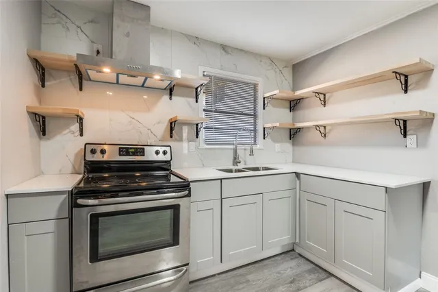 a kitchen with cabinets appliances and a sink