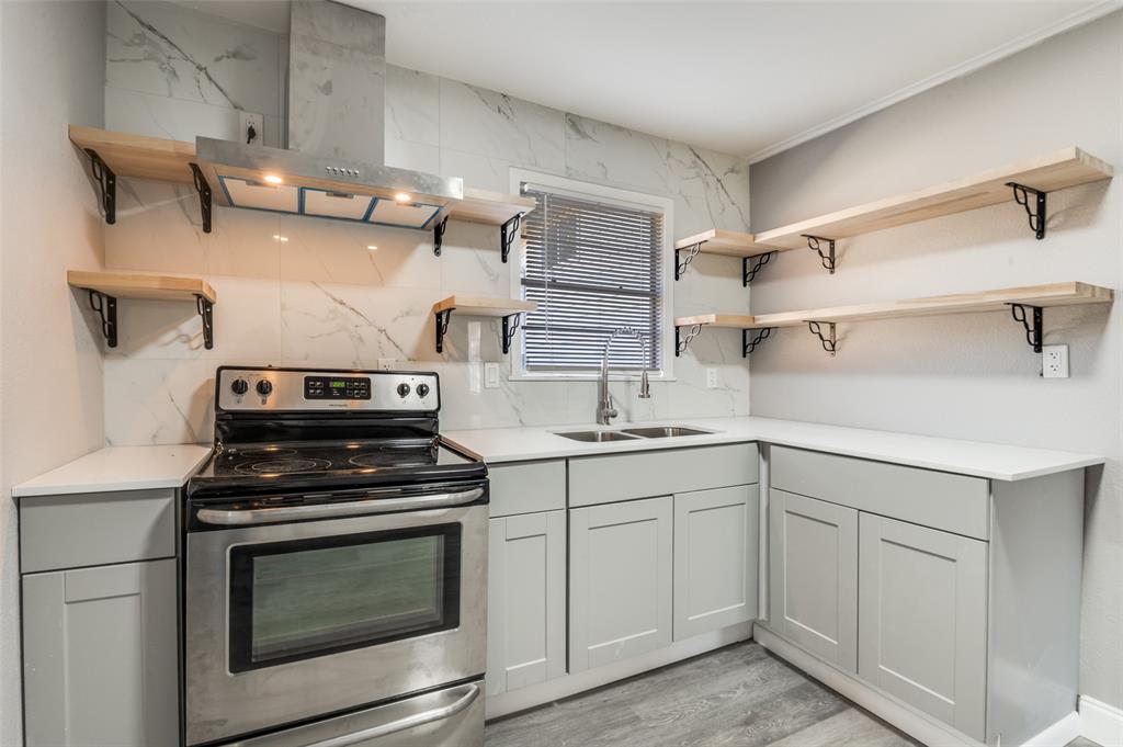 421 West 8th Street Lancaster, TX 75146 - Photo 10 of 25 a kitchen with cabinets appliances and a sink