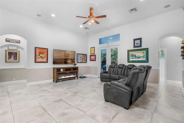 a bedroom with a bed and a refrigerator