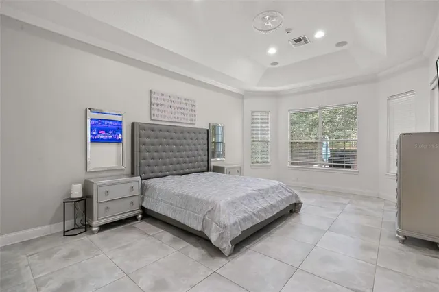 a spacious bedroom with a bed and a window