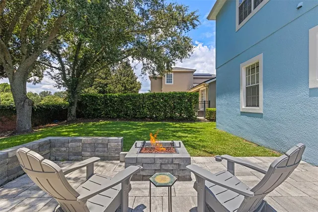 a view of a house with backyard and sitting area
