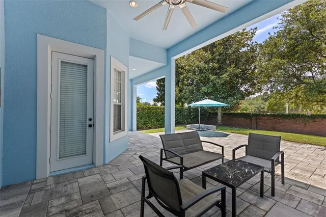a view of a patio with table and chairs under an umbrella