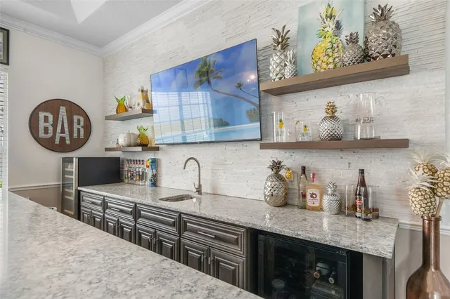 a kitchen with stainless steel appliances granite countertop a sink a stove and wooden cabinets