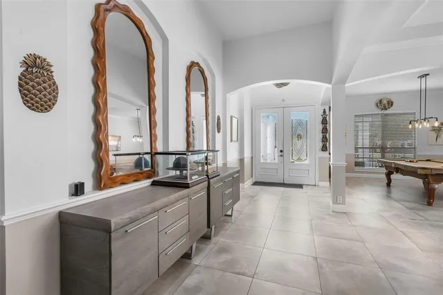 a hall with a sink and a mirror