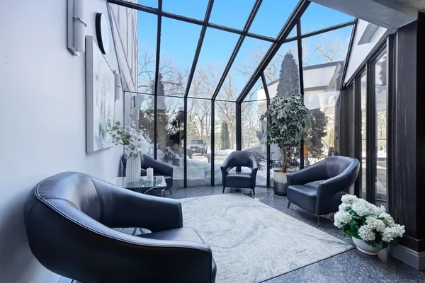 a living room with furniture and a potted plant