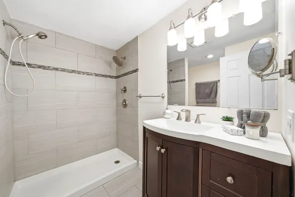 a bathroom with a sink a toilet and shower