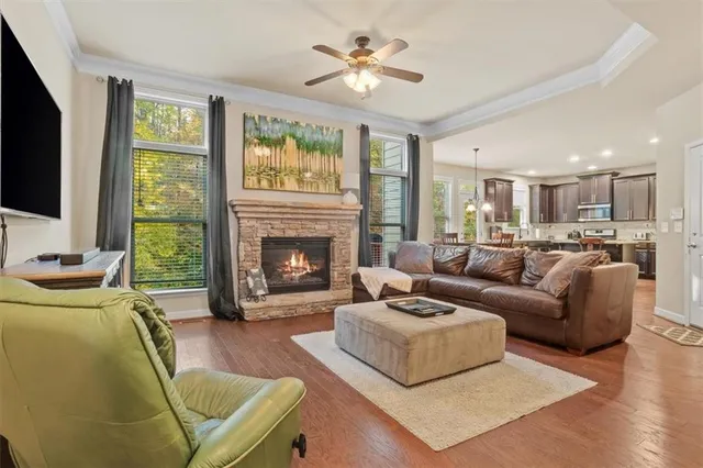 a living room with furniture a flat screen tv and a fireplace