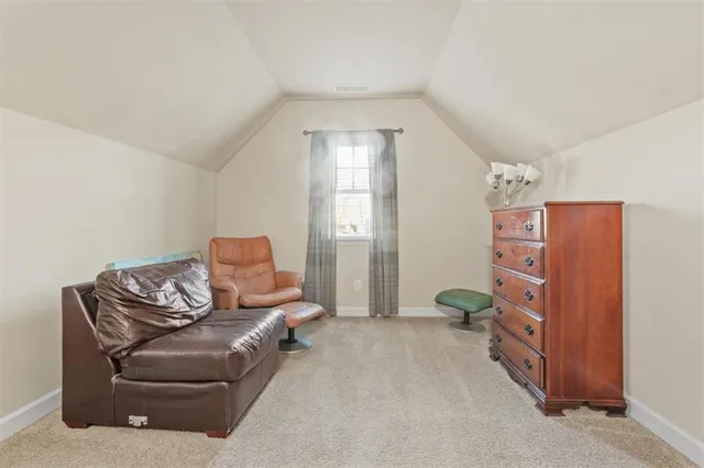 a spacious bedroom with two beds and a chandelier