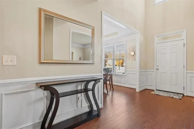 a view of an entryway with wooden floor and stairs