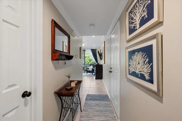 a view of a hallway with wooden floor and stairs