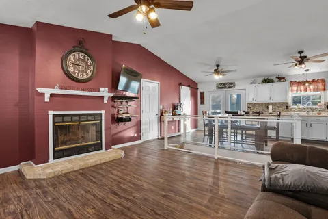 a living room with furniture a clock and a fireplace
