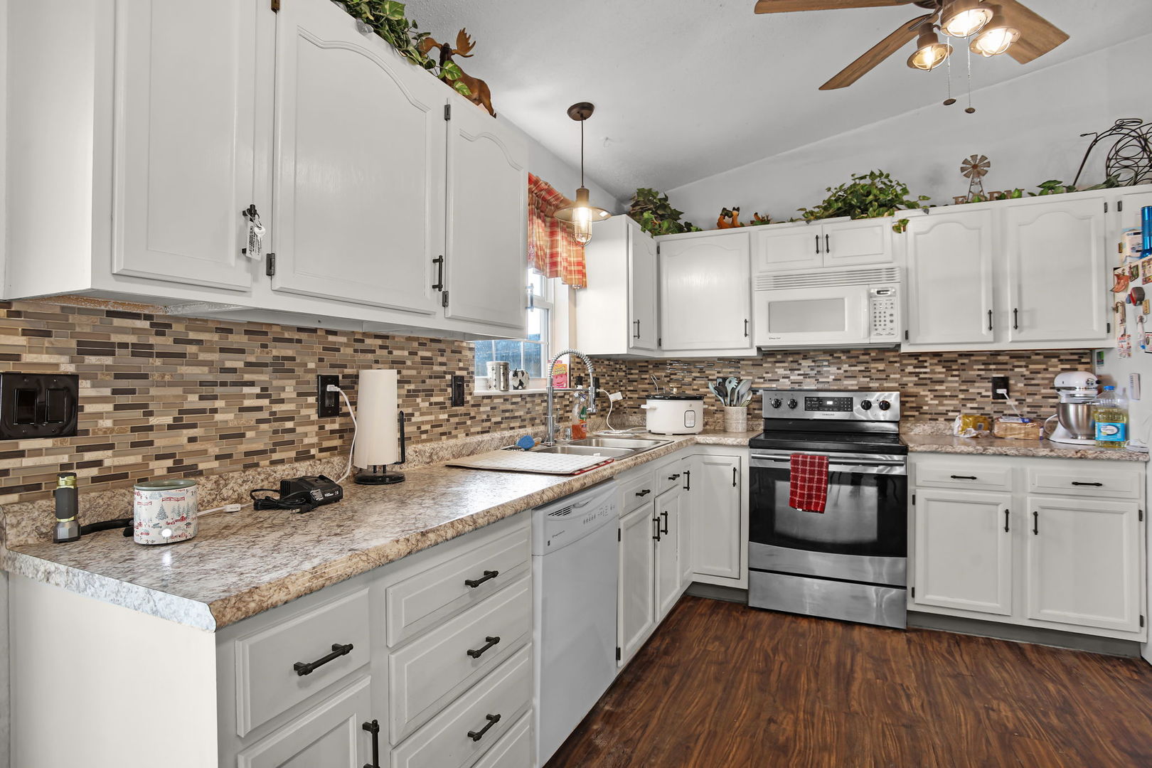 207 Byrn Street Troy, IL 62294 - Photo 6 of 19 a kitchen with granite countertop a sink stainless steel appliances and cabinets