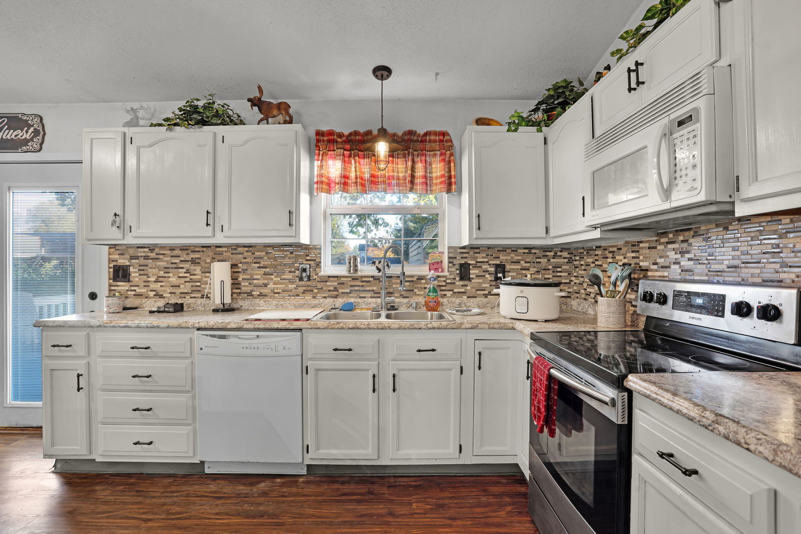 207 Byrn Street Troy, IL 62294 - Photo 7 of 19 a kitchen with granite countertop a sink cabinets stainless steel appliances and a window