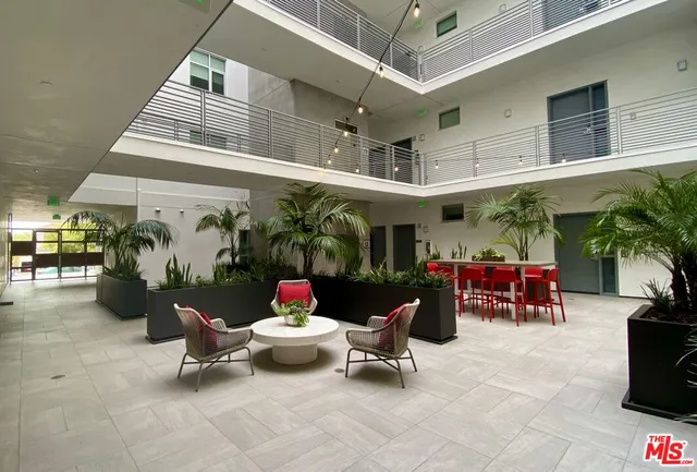 an outdoor space with patio furniture and potted plants
