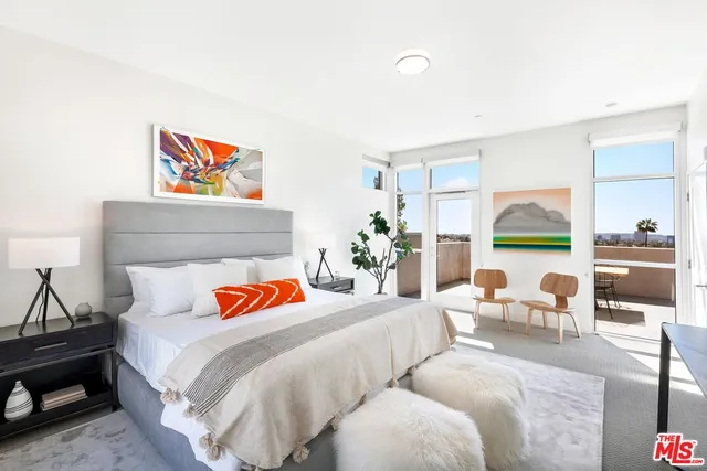 a bedroom with furniture and a painting on the wall