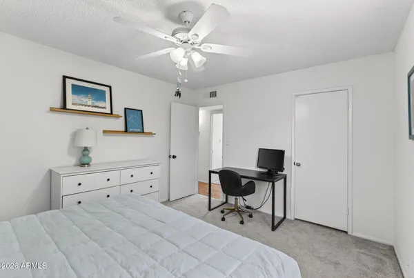 a bedroom with a bed and a table in it