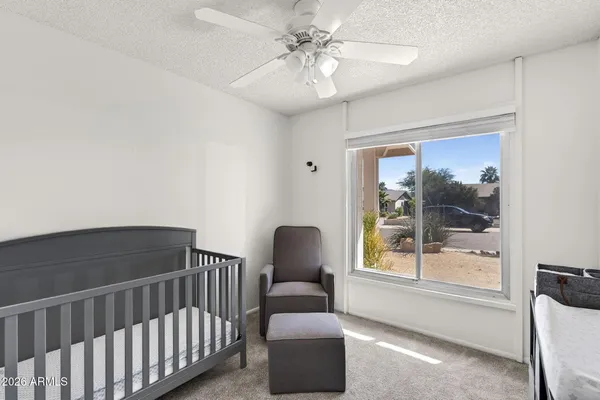 a bedroom with a bed and glass window