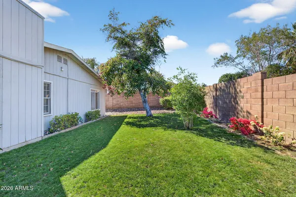 a view of a garden with flowers and trees