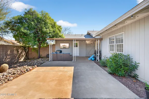 a view of a house with backyard and sitting area