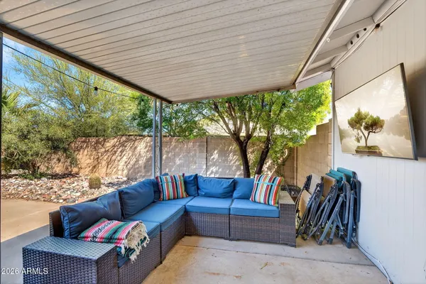 a outdoor living space with furniture and a black umbrella