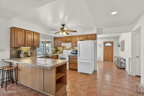 a kitchen with refrigerator and cabinets