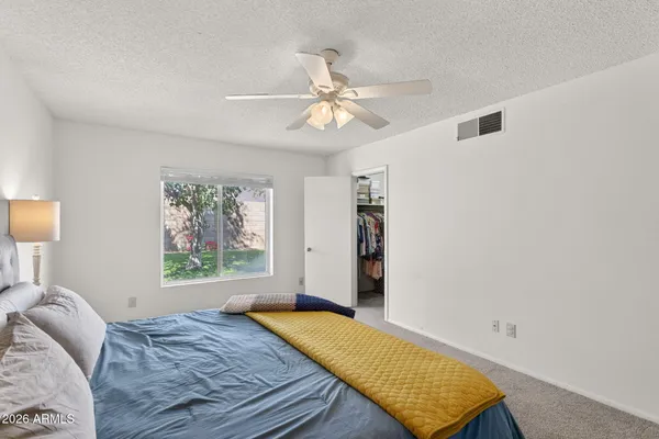 a bedroom with a bed and a window