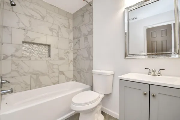 a bathroom with a sink toilet and shower