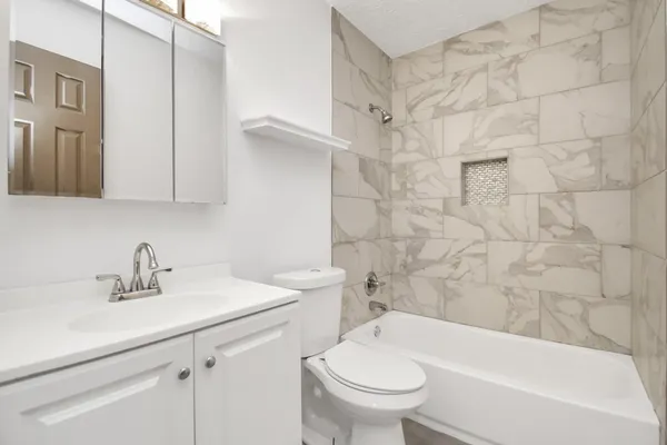 a bathroom with a sink toilet and shower