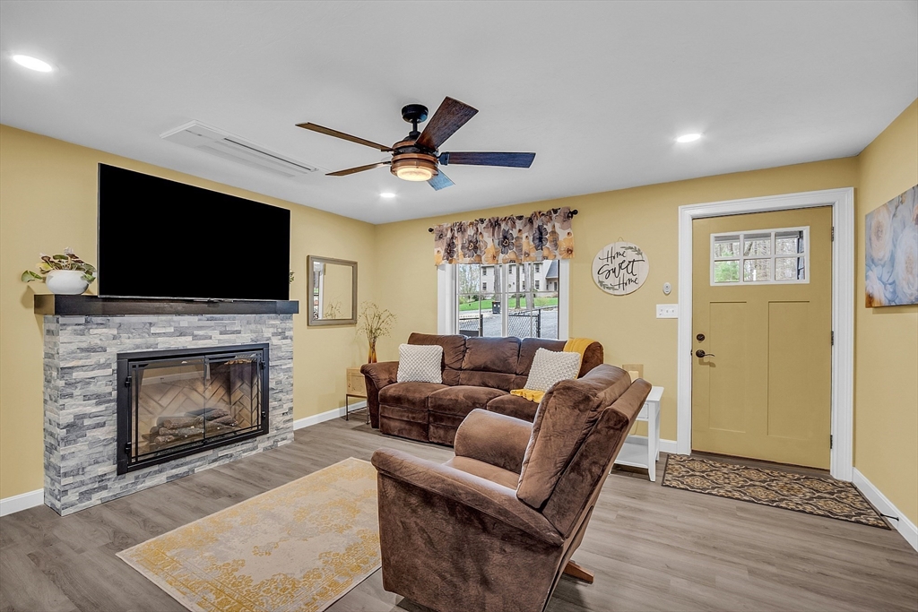 35 Bathrick Westminster, MA 01473 - Photo 11 of 36 a living room with furniture a fireplace and a flat screen tv