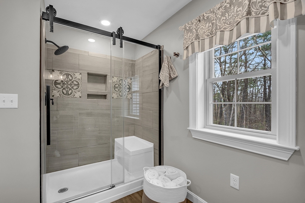 35 Bathrick Westminster, MA 01473 - Photo 18 of 36 a bathroom with a shower a toilet and a window
